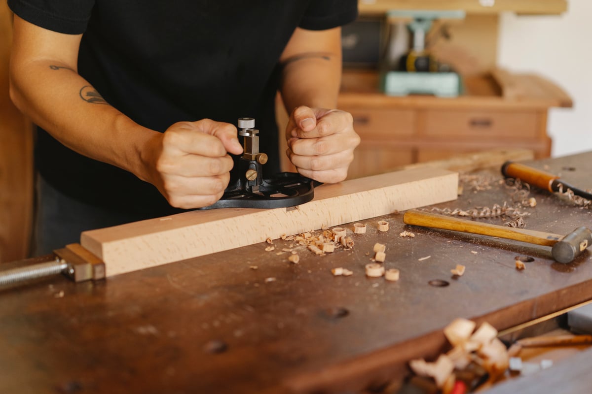 Close Up Photo of Craftsman Crafting Wooden Plank 